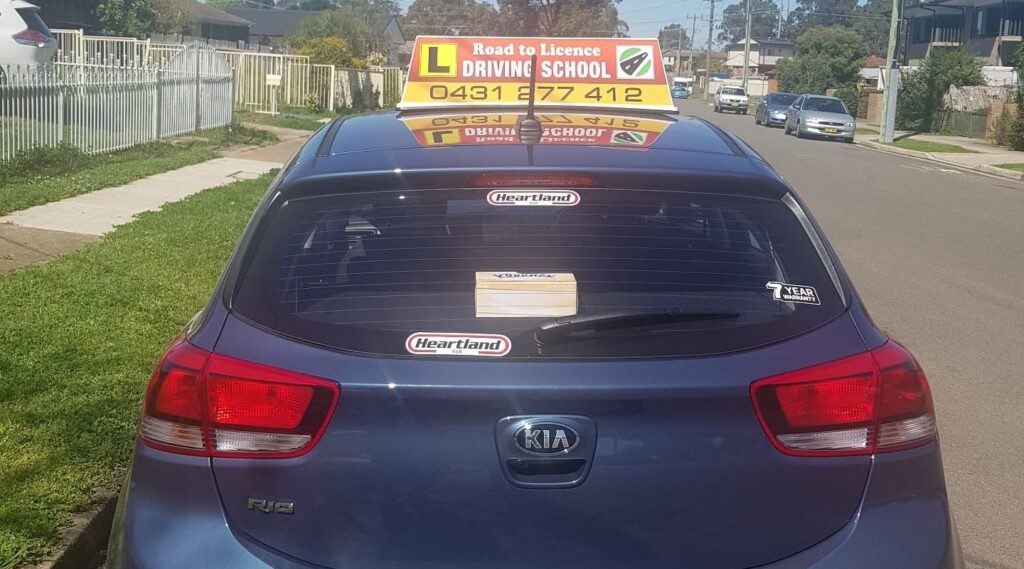 Road to Licence Driving School Kia Rio with L-plate roof sign and phone number 0431 277 412