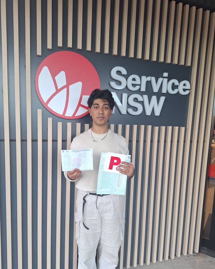 Road to Licence student holding his P plate and test result outside Service NSW